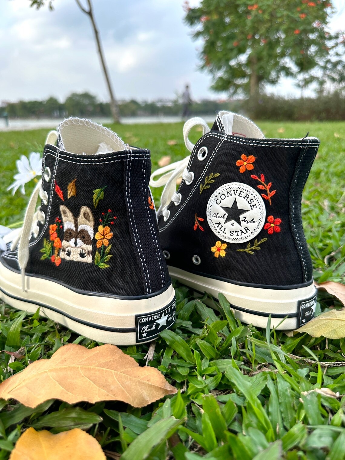 85.5 a1 Converse embroidered raccoons are super cute in the middle of a colorful flower garden.