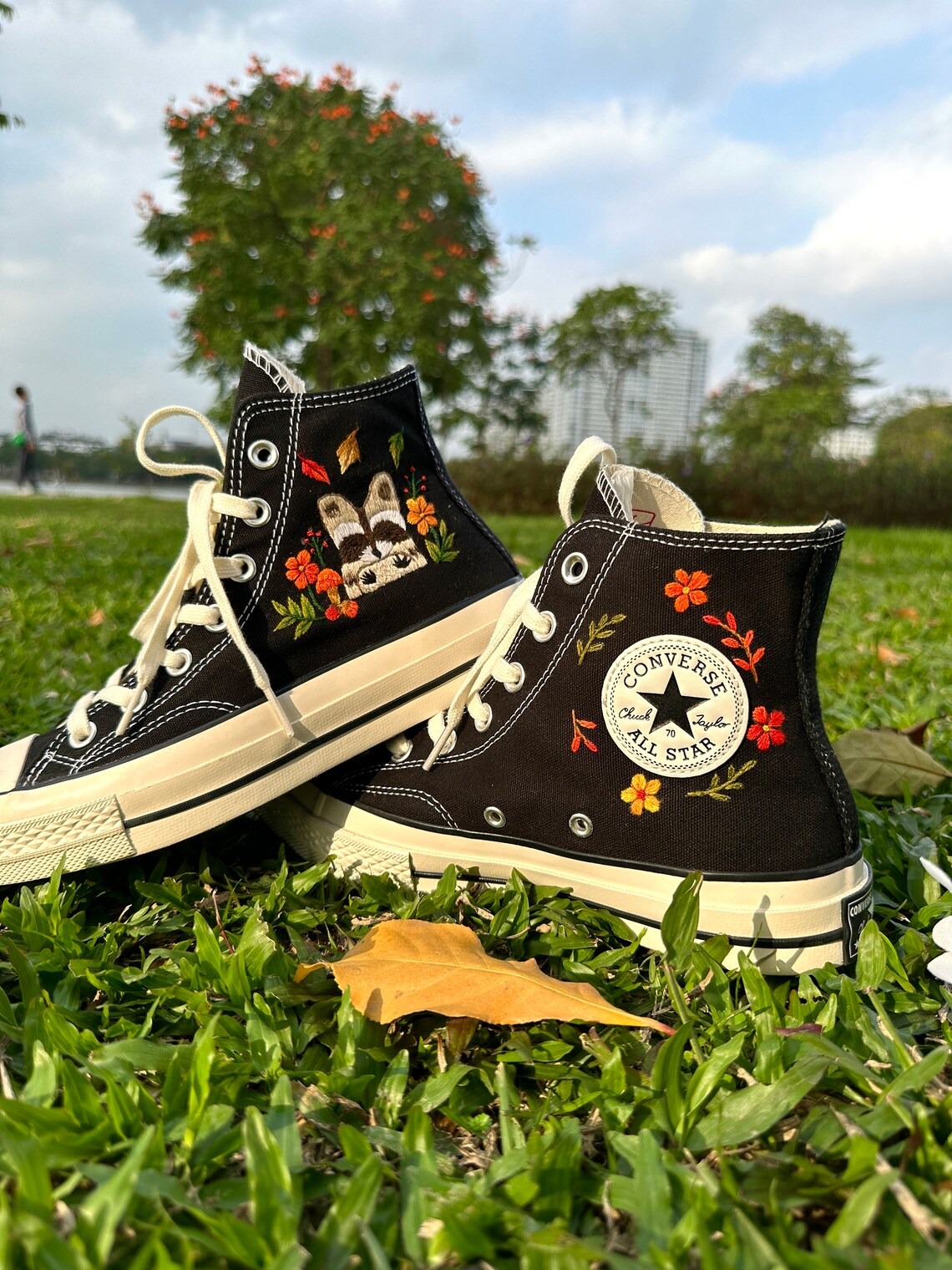 avt Converse embroidered raccoons are super cute in the middle of a colorful flower garden.