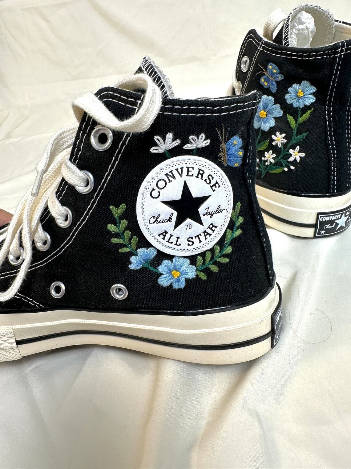 86.5 a4. Converse embroidered high tops with blue flowers and monarch butterflies